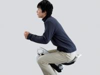 In a semi-crouching position with the device