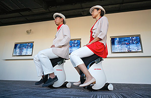 Japan Pavilion attendants riding UNI-CUB &beta;