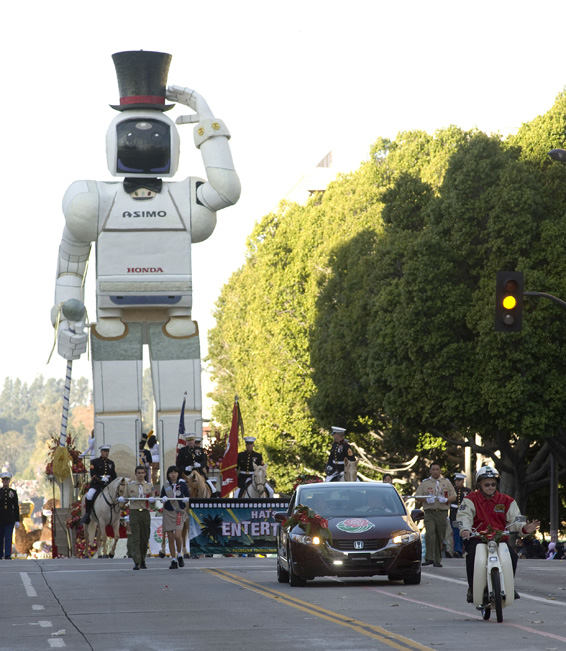 Honda's Rose Parade float featuring a 1959 Honda Super Cub motorcycle, the Honda FCX hydrogen car and a replica of the ASIMO robot, lead off the 120th Rose Parade, New Year's Day, Thursday, Jan. 1, 2009 in Pasadena, Calif. Honda's float which celebrates the company's 50th anniversary in the U.S., won the Theme Award, for excellence in presenting parade theme. Photo/Honda, Susan Goldman, handout.