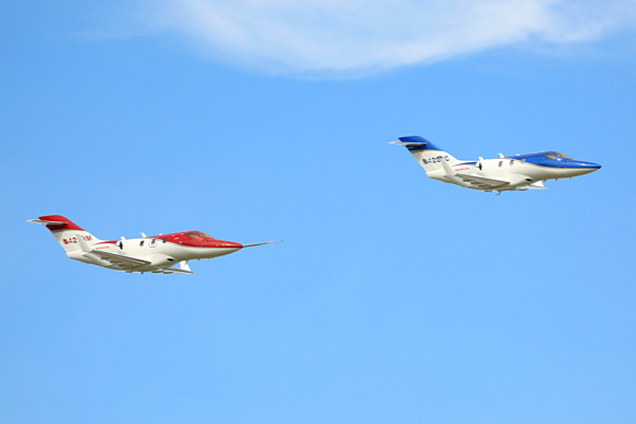 Two FAA-conforming HondaJets concluded the day with a formation fly over at the Experimental Aircraft Association's (EAA) AirVenture Oshkosh 2013 in Oshkosh, Wisc.