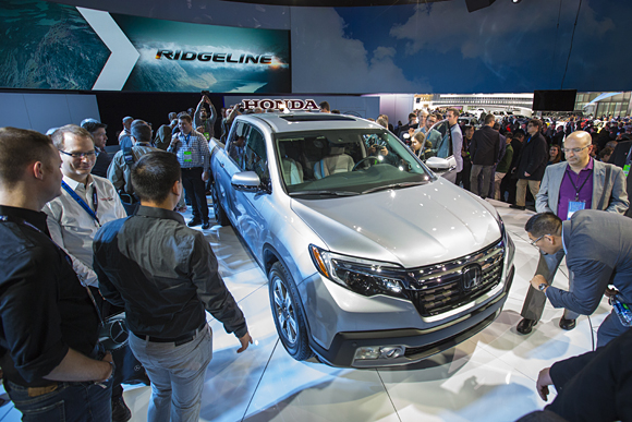 Members of the media get a close look at the all-new 2017 Honda Ridgeline on January 11 at the 2016 North American International Auto Show in Detroit.