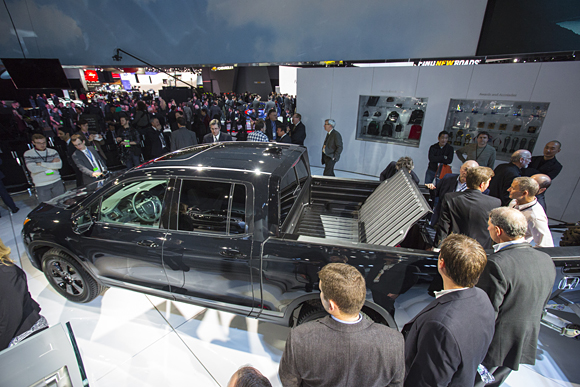 Members of the media get a close look at the all-new 2017 Honda Ridgeline on January 11 at the 2016 North American International Auto Show in Detroit.