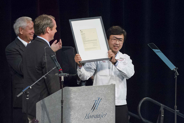 Melvin Johnson, FAA Small Aircraft Directorate Manager for the Central Region presented the Production Certificate to Honda Aircraft Company President and CEO Michimasa Fujino on Friday, July 8.