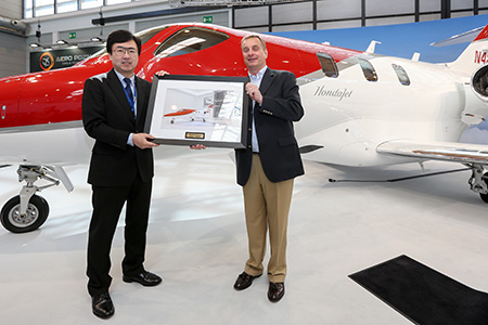 Honda Aircraft Company President and CEO Michimasa Fujino participates in a ceremonial delivery with Johannes Graf von Schaesberg, chairman and CEO of Rheinland Air Service. 