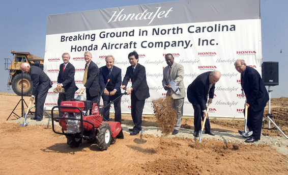 Tony Copeland, North Carolina Assistant Secretary of Commerce, left and Michimasa Fujino, left, President and CEO of Honda Aircraft Company, Inc share the duties on a Honda tiller as they break ground for the future world headquarter of Honda Aircraft Company, Inc facility in Greensboro, NC Wednesday June 27, 2007. From left to right: John Faircloth, Interim Mayor of High Point; Allen Joines, Mayor of Winston-Salem; Keith Holliday, Mayor of Greensboro; Tony Copeland, Assistant Secretary of Commerce, State of North Carolina; Michimasa Fujino, President & CEO of Honda Aircraft Company; Lonnie Miles, President of Miles McClellan Construction, Co.; Ted Johnson, Executive Director of PTI; and, Henry Isaacson, President of PTI Board of Directors.