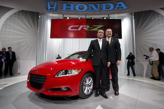 Detroit - January 11, 2010 - Takanobu Ito, president and CEO, Honda Motor Co., Ltd. (left) and John Mendel, executive vice president, American Honda Motor Co., Inc., introduced the production version of the all-new 2011 CR-Z Sport Hybrid at the North American International Auto Show today. Featuring a 1.5 liter i-VTEC 4-cylinder engine with Honda's Integrated Motor Assist (IMA) Hybrid System, CR-Z has a 10 kW electric motor that produces an estimated 122 horsepower and allows drivers to choose sport, normal or economy performance. Honda CR-Z standard features include; vehicle stability assist, six airbags, 16-inch alloy wheels, auto climate control and ABS. Honda CR-Z is available with a 6-speed manual transmission or a continuously variable transmission. (Joe Wilssens photo)