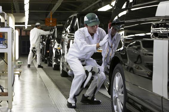 Honda developed the Bodyweight Support Assist device to help support bodyweight to reduce the load on the user's legs while walking, going up and down stairs and in a semi-crouching position, such as these associates demonstrate in Honda's Saitama Factory in Japan.