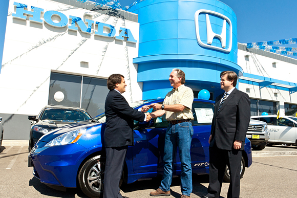 Steve Center (left), vice president of the Environmental Business Development Office at American Honda and Elmer Hardy (right), senior manager, Alternative Fuels & Advanced Technologies, present Ventura County, Calif., resident Matt Walton (center) with the keys to the first 2013 Honda Fit EV, now available on-lease in select California and Oregon markets.