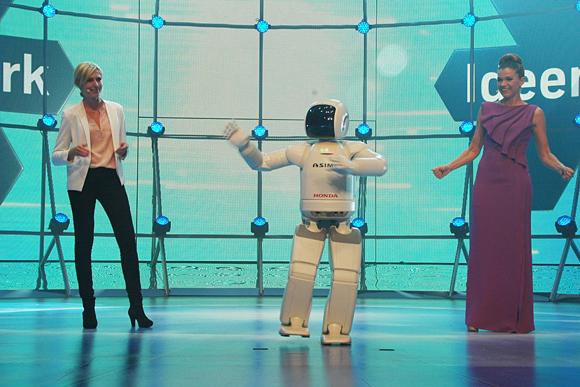 ASIMO entertains the audience with a dance at the Night of Innovation, the gala opening of IdeenPark, Essen, Germany