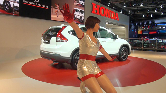 A rider takes the U3-X for a spin on the Honda stand