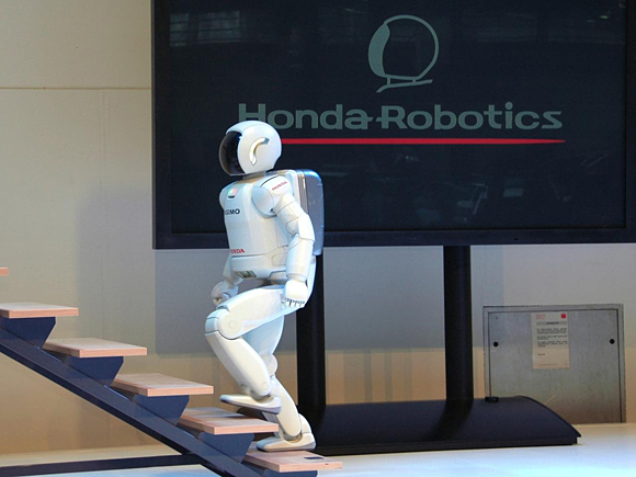 ASIMO showcases it's ability to climb stairs at the opening party