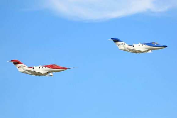 Two FAA-conforming HondaJets concluded the day with a formation fly over at the Experimental Aircraft Association's (EAA) AirVenture Oshkosh 2013 in Oshkosh, Wisc.