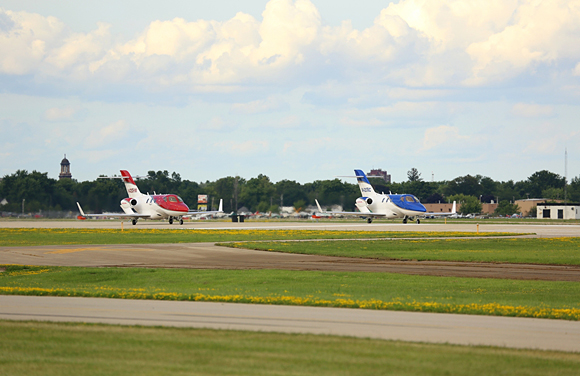 Two HondaJets takeoff for a special flight demonstration at Experimental Aircraft Association's (EAA) AirVenture Oshkosh 2013 in Oshkosh, Wisc. Monday afternoon.