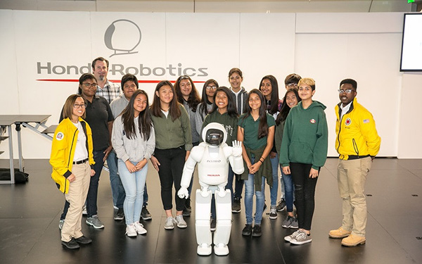 City Year students pose with Honda's ASIMO humanoid robot at a recent STEM education event.