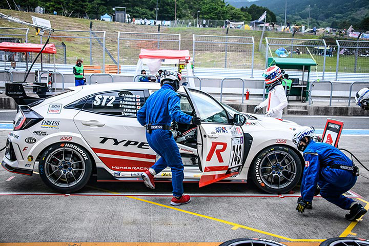 Mechanics quickly refuel the car and change its tires during a driver change.