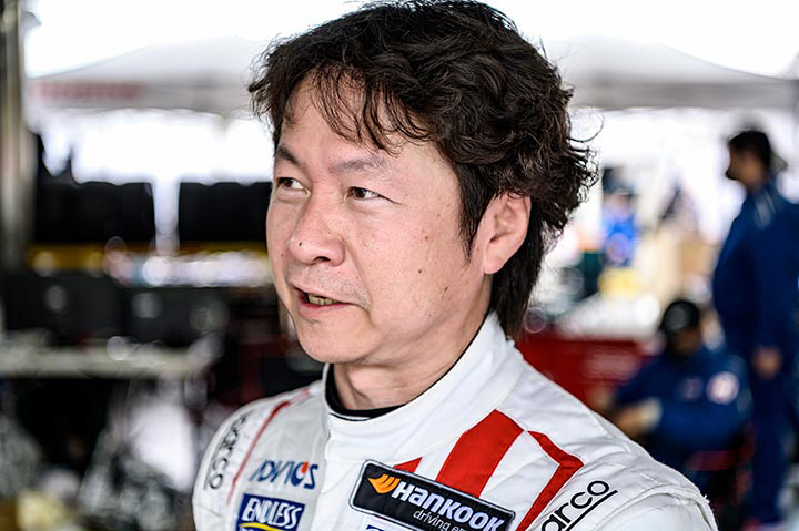 In his racing suit, Kakinuma looks every bit the professional racing driver.