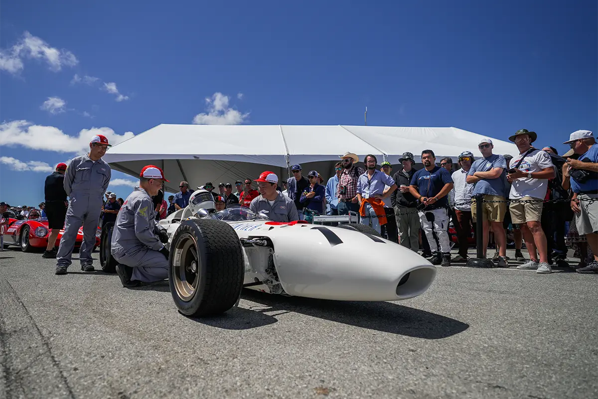 Fans watch as the RA272 is maintained