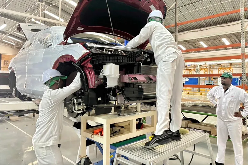 SKD factory production line in Ghana. Imported parts are assembled, including painted body panels, complete engine and transmission units, and interior and exterior component