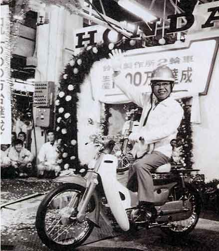 Soichiro Honda sits astride the Super Cub with a big smile on his face. By 1971, motorcycle production at Honda's Suzuka Plant had surpassed the 10 million units mark.